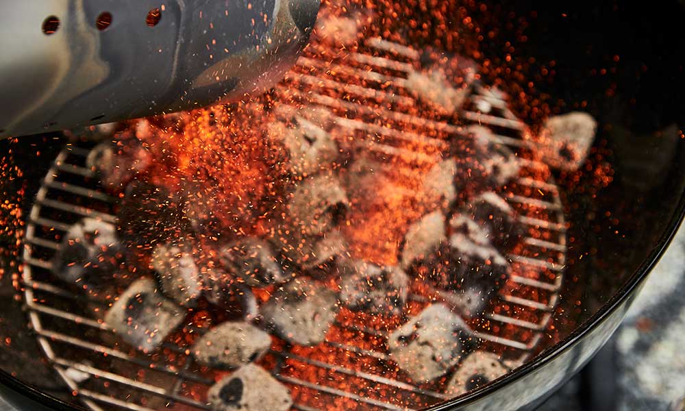 Pouring Briquettes onto a BBQ