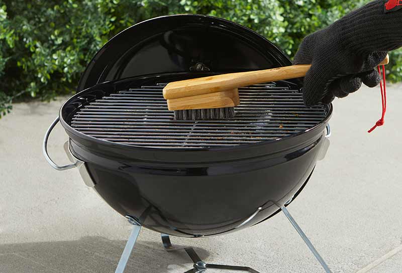 Scrubbing BBQ with Wire Brush