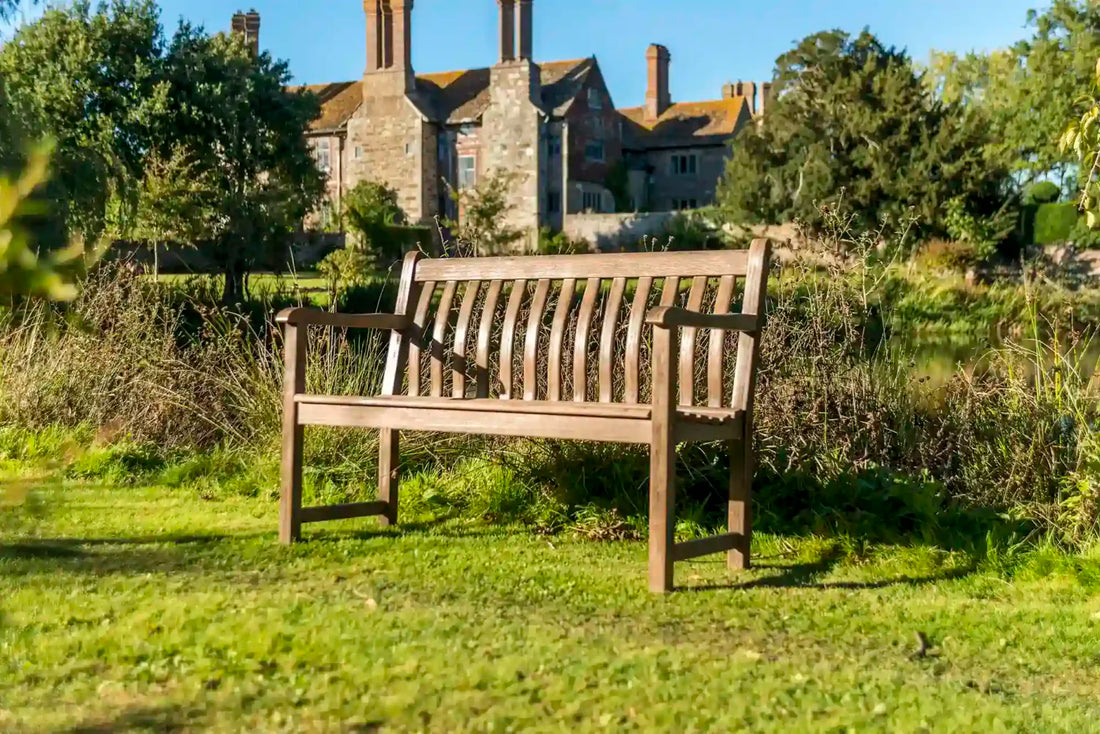 Wooden Garden Bench in front of a house in the country