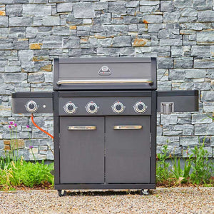 Gray Grillstream barbecue grill with brand logo against a stone wall background