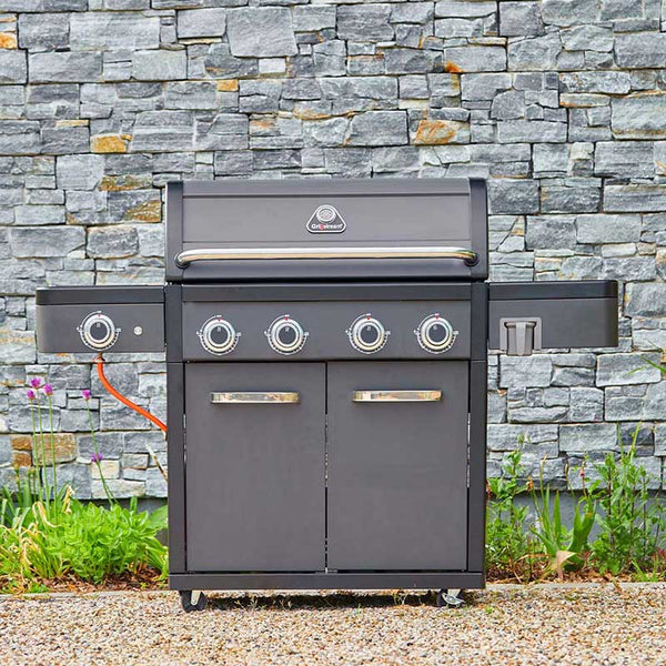 Gray Grillstream barbecue grill with brand logo against a stone wall background