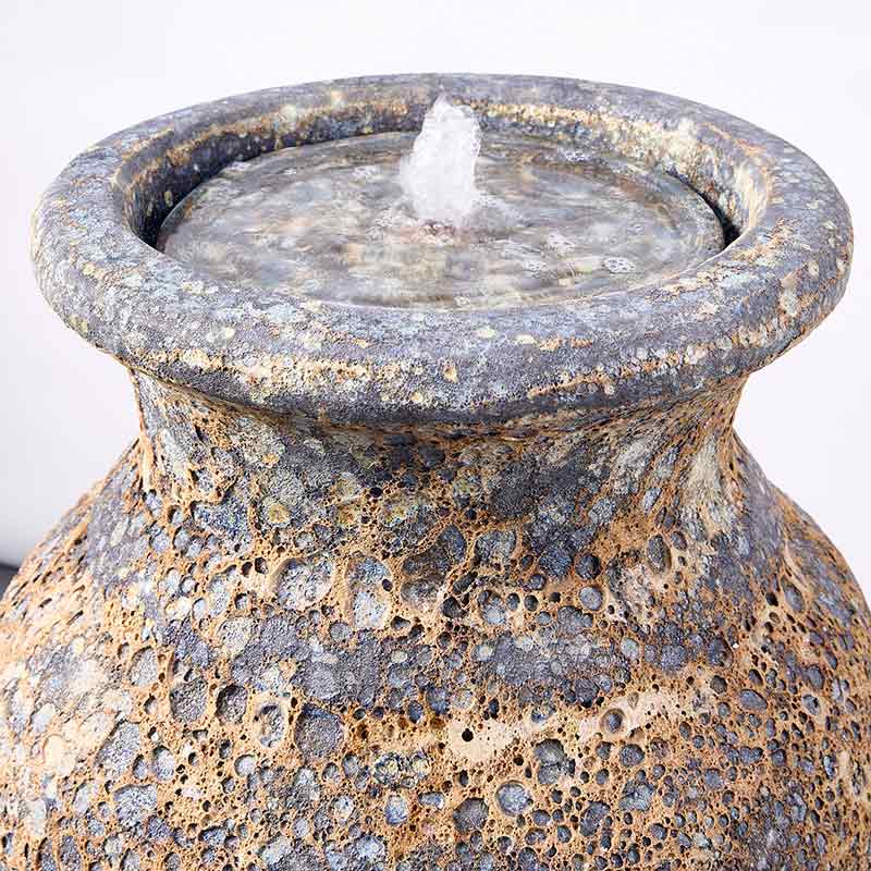 A rustic Altico Milani Rustic Grey ceramic water feature that has a heat-treated aged and textured appearance with mottled gray, brown, and beige tones, shown against a plain white background.