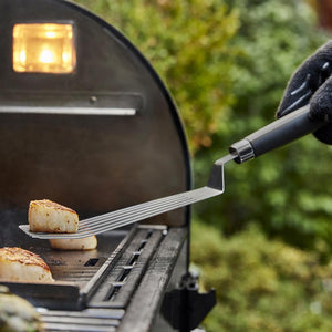 Weber Flexible Griddle Spatula in use lifting scallops from the griddle