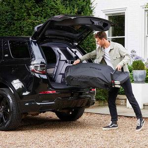 Loading a Weber Traveler Portable Gas Barbecue into the boot of an SUV