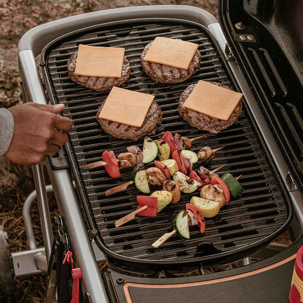 Weber Traveler Portable Gas Barbecue in use with burgers