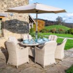 Bramblecrest Monterey Sandstone 6 Seat Elliptical Dining Set with Parasol & Base in garden X21WSMO175EL1
