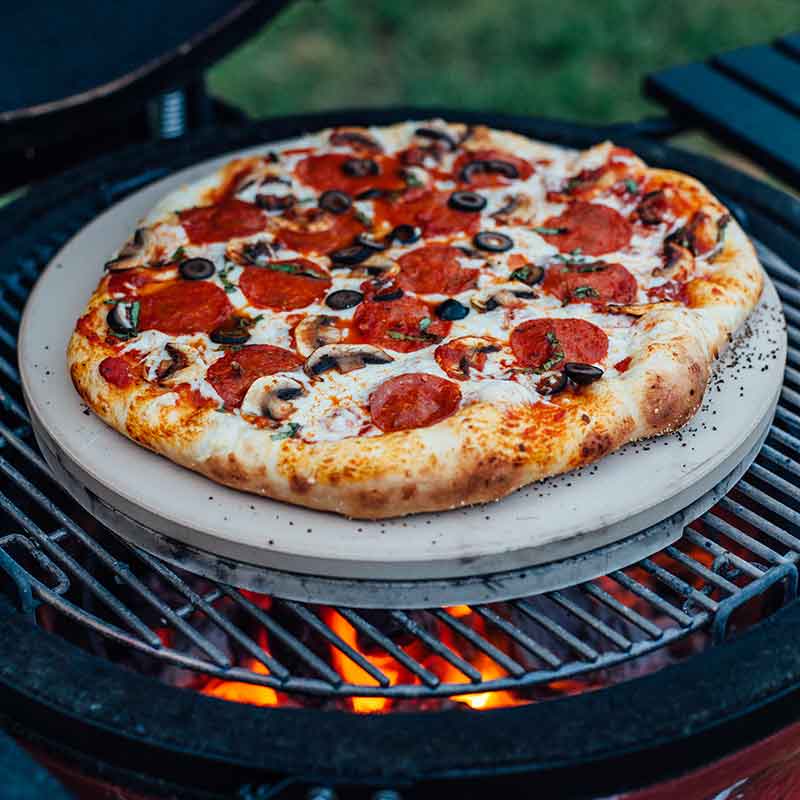 Crispy pizza on a charcoal Kamado Joe barbecue