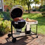 Weber Summit Kamado S6 Charcoal Grill Centre with the lid open in garden