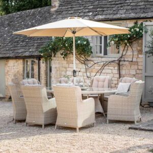 Bramblecrest Chedworth 8 Seat Outdoor Dining Set in Sandstone with Elliptical Table, Lazy Susan, Parasol & Base