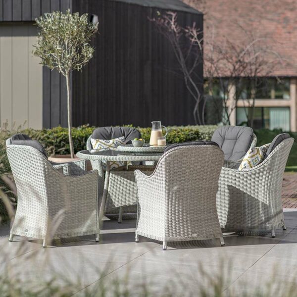 Bramblecrest Monterey Dove Grey 6 Seat Round Dining Set with Lazy Susan, Parasol & Base on patio