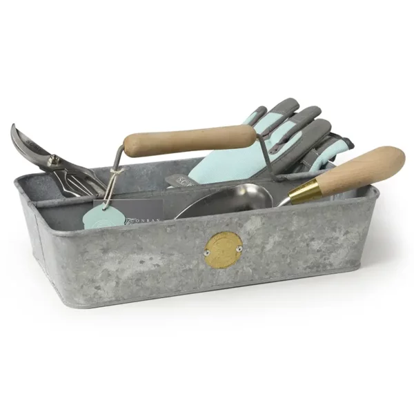 A metal Burgon & Ball Sophie Conran Galvanized Trug holding a selection of other gardening tools and gloves.