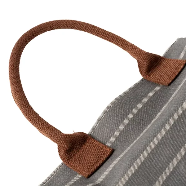 The brown handle of the grey and white striped Burgon & Ball Sophie Conran Garden Kneeler.