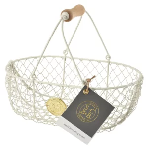 A Burgon & Ball wire basket with a wooden handle on a white background. The basket is large and sturdy, with a mesh construction. The basket has been painted a buttermilk colour.