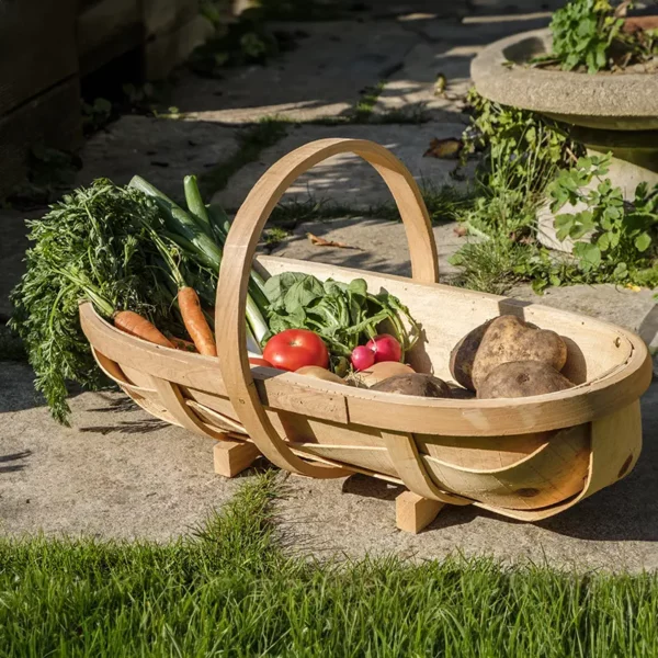 The Burgon & Ball Large Traditional Wooden Trug sat on a patio holding homegrown vegetables.