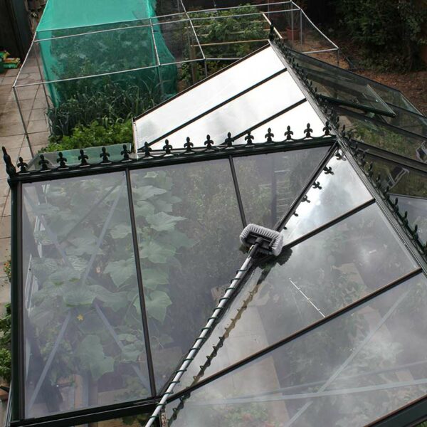 The Darlac Telescopic set cleaning the top of a greenhouse.
