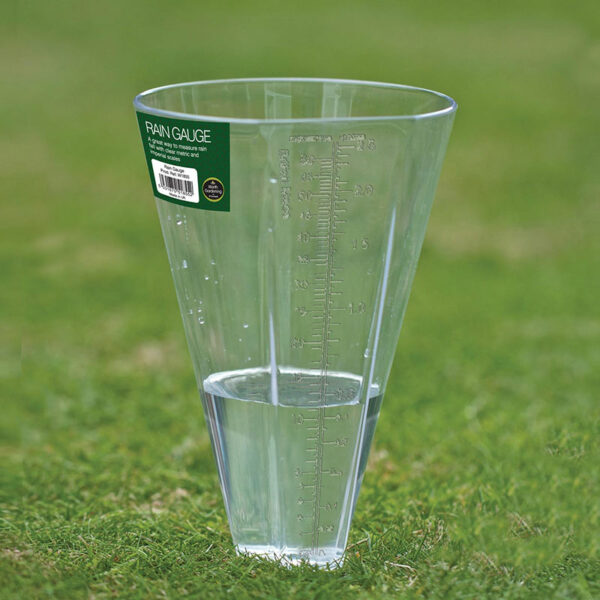 A see-through, plastic Garland Rain Gauge cup, staked in grass with just over 10cm of water in it.