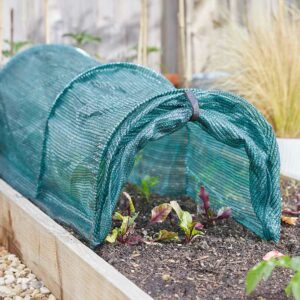 An open, highly-durable mesh tunnel over a row of juvenile plants in a raised bed. The end is open and tied up.