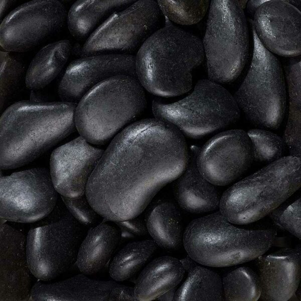 A close view of glossy black pot topper stones. The stones are rounded and smooth, between 15 and 35mm.
