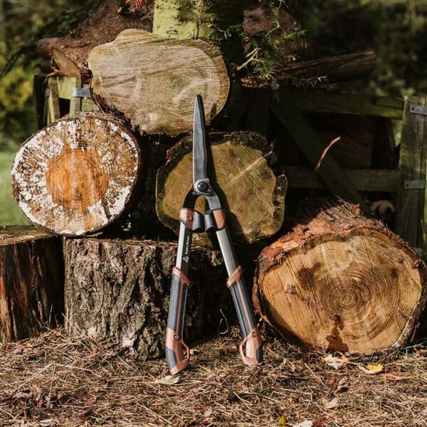 Kent & Stowe SureCut Hedge Shears in situ leaning against logs
