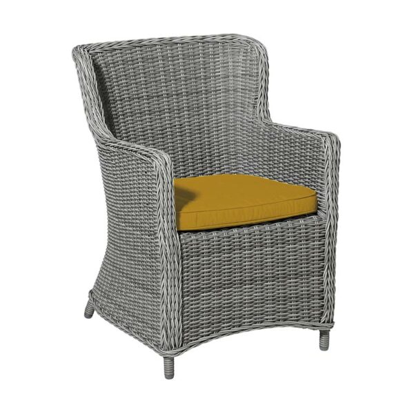 Madison Outdoor Wicker Seat Cushion in Gold shown in use on rattan garden chair