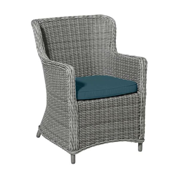 Madison Outdoor Wicker Seat Cushion in Sea Blue shown in use on wicker rattan garden chair