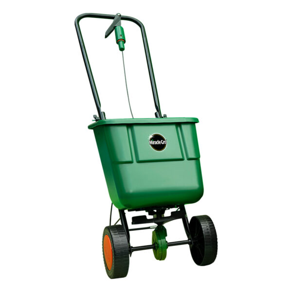A green Miracle-Gro rotary lawn spreader with a hooped metal handle.