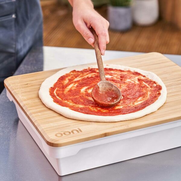 Preparing a pizza on the Ooni Dough Proofing Boxes