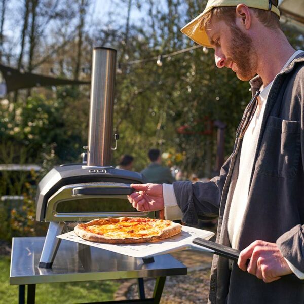 Ooni Karu 12G Pizza Oven in use with man