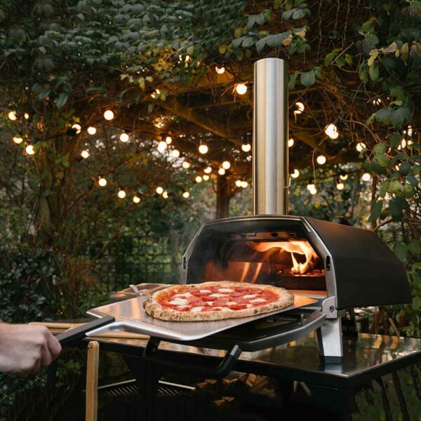 The Ooni Karu 16 Pizza Oven in use in a garden