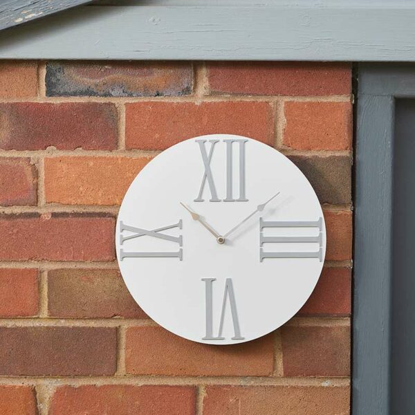 The Outside In Moda Cream Wall Clock in situ outdoors on brick