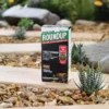 A pack of Roundup Tree Stump Weedkiller sat on a plank in a garden