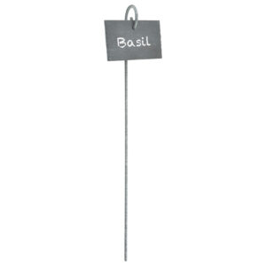 A slate, rectangular plant marker hanging from a loop at the top of a large metal peg. The word 'Basil' is written on it.