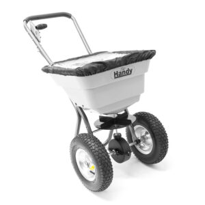 A heavy-duty, hand-pushed lawn spreader. It has large, rugged wheels and a black rimmed elastic cover to contain the contents.