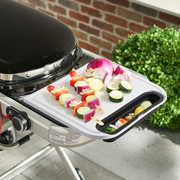 Weber Cutting Board with Catch Bin in use with Traveler BBQ