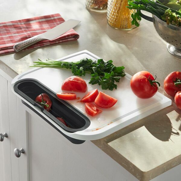 Weber Cutting Board with Catch Bin in use on kitchen worktop