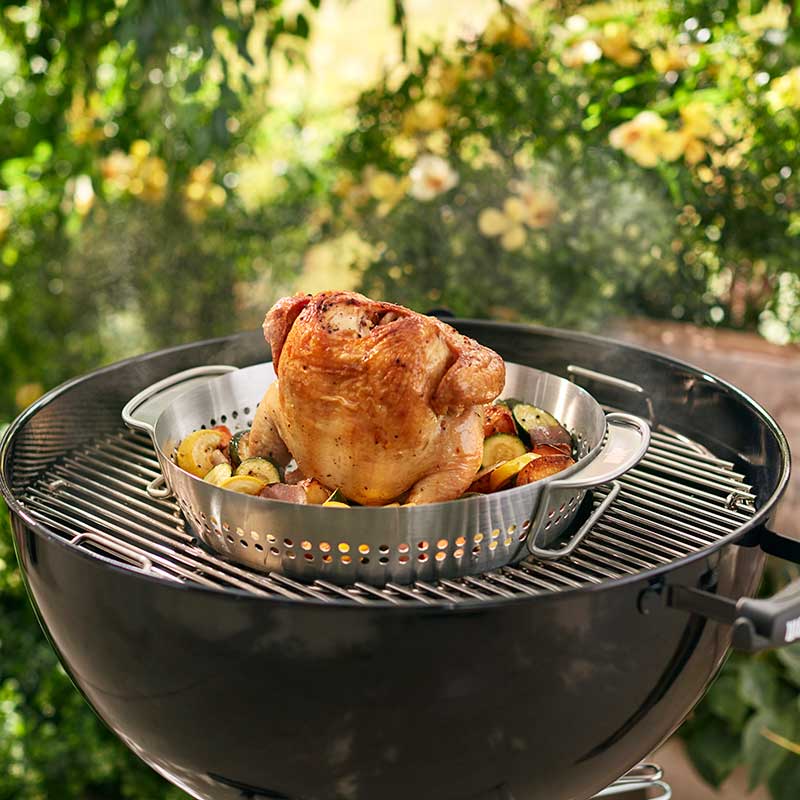 Weber GBS Poultry Roaster with a charcoal BBQ