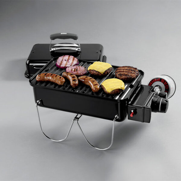 The Weber Go-Anywhere Portable Gas Barbecue in use grilling sausages and burgers