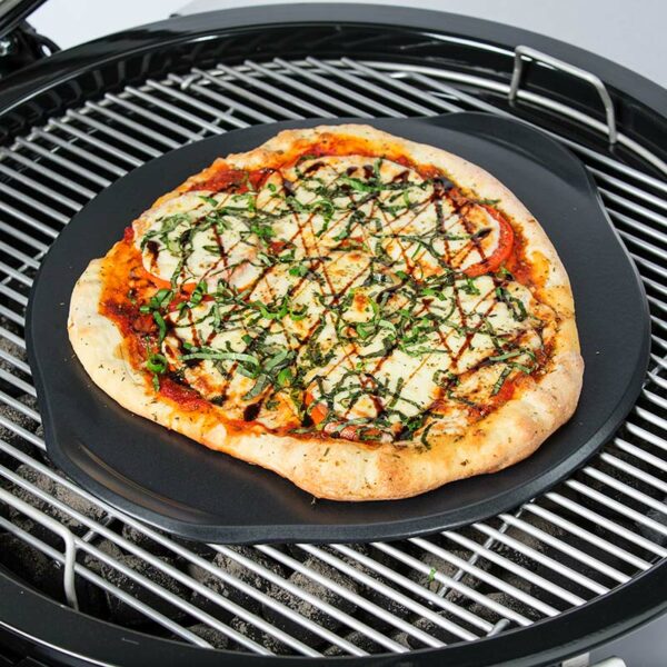 pizza cooking on the Weber Premium Ceramic Glazed Grilling Stone (46cm)
