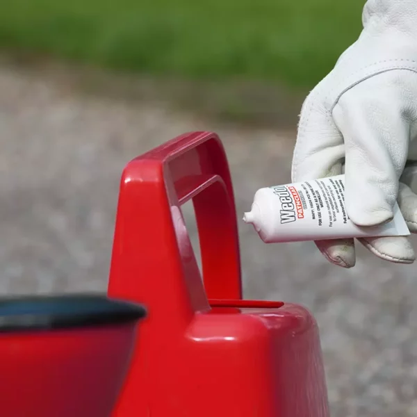 A Weedol PathClear Weedkiller Concentrate Tube being emptied into water