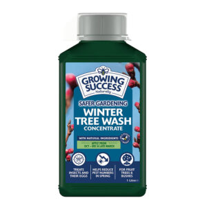 A bottle of Westland Growing Success Winter Tree Wash with a child proof cap and measuring cup.