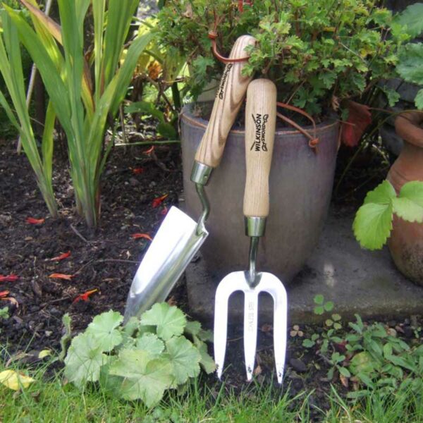 A Wilkinson Sword Stainless Steel Hand Trowel next to a matching hand fork.