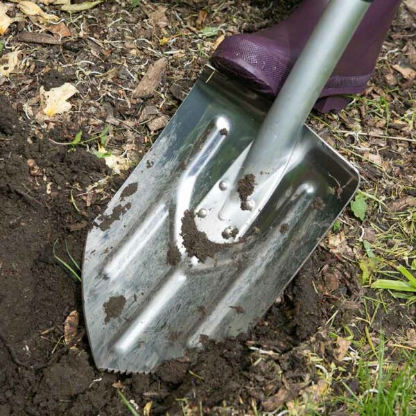 A muddied Wilkinson Sword Ultralight Digging Spade.